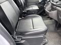 Interior of a 2023 Ford Transit highlighting the black front seats with armrests and a clean, modern design
