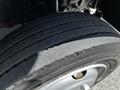 Close-up view of a Hino 195 tire showing tread patterns and a metallic rim