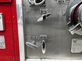 Close-up of metal controls and valves on a 1991 Sutphen Deluge fire truck showcasing levers and identification plates