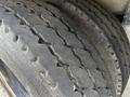 Close-up of worn tires on a 2013 K-Line 16 Foot Steel Tandem Pony 17 Ton Dump Trailer with Air Weigh showing visible tread patterns and signs of use