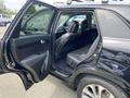 A 2015 Kia Sorento with the back door open showing the leather interior and spacious seating arrangement inside the vehicle