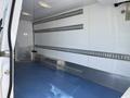 A 2016 Mercedes-Benz Sprinter van interior showing empty cargo space with blue flooring and metal storage tracks on the walls
