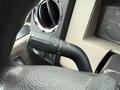 Close-up of the turn signal lever inside a 2008 Ford F-350 with markings for signal activation and off position