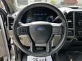 A steering wheel of a 2017 Ford F-250 SD featuring the Ford logo and controls for various functions