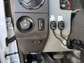 Close-up of the dashboard controls in a 2015 Ford F-550 showing knobs and toggle switches for lights and settings
