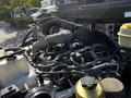 A close-up view of the engine compartment of a 2021 Hino 338 showing various hoses wires and engine components
