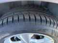Close-up of a tire from a 2014 Ford Escape showing detailed tread pattern and the brand name on the sidewall