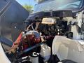 Close-up of the engine compartment of a 2018 International DuraStar showing various engine components and hoses
