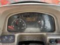 Dashboard of a 2011 Kubota M8540D tractor showing gauges for speed fuel temperature and hours used with visible dust and scratches on the surface