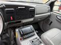 Interior of a 2007 Ford F-550 featuring a dashboard with control buttons a touch screen and seatbelts on the passenger seat