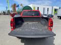 A red 2012 RAM 2500 pickup truck with an open bed displaying a black rubber liner and no visible cargo