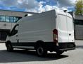 A white 2015 Ford Transit van is positioned at an angle showing its rear and side with no visible branding or design elements on the exterior
