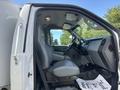Interior view of a 2016 Ford F-750 showing gray leather seats and dashboard with controls visible