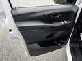 The interior door panel of a 2020 Mercedes-Benz Metris featuring controls for windows and locks with a smooth black finish and an ergonomic handle