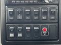 Panel of switches and buttons from a 2017 International WorkStar 7600 including controls for radar, locking, and body functions