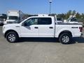 A white 2017 Ford F-150 with a crew cab configuration and 4x4 badge parked in a lot