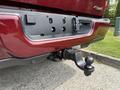 A 2024 RAM 3500 truck's rear bumper displaying a tow hitch with a ball mount attached