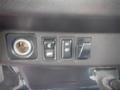 Control panel featuring four buttons including a key slot a power switch and two additional switches in a vehicle