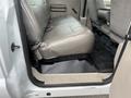 Interior view of a 2010 Ford F-250 SD showing the rear bench seat and floor mat
