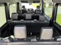 Interior view of a 2019 Mercedes-Benz Sprinter showing rows of black leather seats with a focus on the driver and passenger area