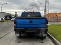 A blue 2021 RAM 1500 Classic pickup truck viewed from the rear with dual exhausts and a 4x4 badge on the tailgate