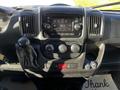 Interior dashboard of a 2021 RAM Promaster featuring a touchscreen display climate control knobs and gear shift lever