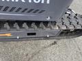 Close-up of a tread and undercarriage of a 2024 AGT Mini Excavator showcasing the track design and metal components