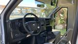 Interior view of a 2011 Chevrolet Express showcasing the dashboard steering wheel and central controls