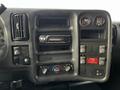 Interior dashboard of a 2006 GMC C5000 featuring a radio, climate control knobs, and several buttons and an indicator gauge