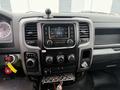 The dashboard of a 2016 RAM 1500 featuring a touchscreen display radio climate controls and gear shift lever