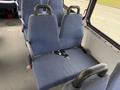 A blue upholstered passenger seat with a seatbelt in a 2017 Chevrolet Express van