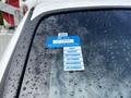 A 2016 Ford F-550 with a blue certificate of approval sticker attached to the windshield displaying the year 2025 and months of the year from August to December
