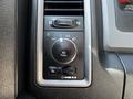 A control panel featuring various knobs and buttons for adjusting headlights and dashboard lighting in a 2016 RAM 2500