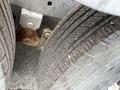 Close-up of two tires of a 2011 Hightliner Aquacide Hot Water Weed Control Dual Flat Deck Trailer showcasing tread patterns and wear