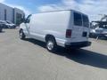 A white 2009 Ford Econoline van viewed from the rear and side angle with a simple design and no visible branding