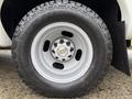 A close-up of a silver wheel and tire from a 2013 Chevrolet Express showing the Chevrolet logo in the center of the wheel
