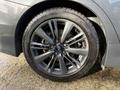A close-up view of a 2021 Subaru WRX wheel featuring sleek alloy spokes and a performance tire showcasing a distinctive tread pattern