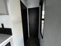Interior hallway of a 2022 Heartland Torque featuring a black door on the left and a window on the right with white walls and a wood-like floor