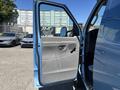 A blue 2008 Ford E-350 van with an open passenger door showing a gray interior and control panel