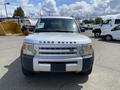 A white 2006 Land Rover LR3 viewed from the front with a prominent LAND ROVER logo on the grille and round headlights