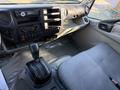 Interior view of a 2014 Hino 195 showing the dashboard with controls and gear shift alongside the driver's seat