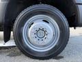Close-up of a silver wheel from a 2020 Ford F-550 showing the tire tread and bolt pattern