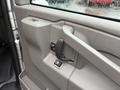 Close-up of the door handle and window controls on a 2023 GMC Savana interior door