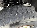 Close-up of a treaded tire from a 2009 Ford F-550 showcasing its rugged design and deep grooves for traction