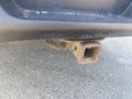 A metal hitch receiver attached to the rear of a 2017 Ford F-150