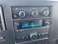 Interior dashboard of a 2023 GMC Savana showing radio display and climate control knobs