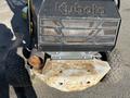 A 2010 Kubota F3990 featuring a black body with prominent grill design and a rusted metal front plate alongside textured tires