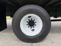 Close-up of a black tire with a white rim labeled Continental mounted on a truck chassis