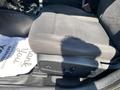 A black cloth seat of a 2019 Dodge Charger is shown with controls on the side and a white mat partially visible beneath it