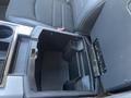 The interior view of a 2011 RAM 1500 center console showing an open storage compartment with a textured black finish